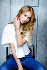 Portrait of young beautiful woman. Long, light, wavy hair and makeup