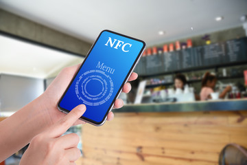 woman hand using smart phone in coffee shop for select coffee me