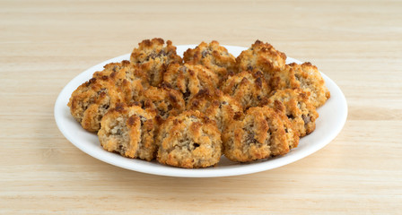 Chocolate chip macaroons on dish atop a wood table