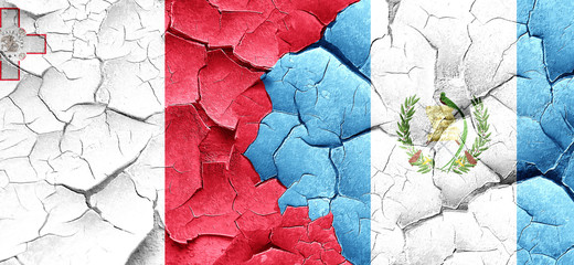 Malta flag with Guatemala flag on a grunge cracked wall