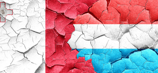 Malta flag with Luxembourg flag on a grunge cracked wall