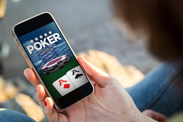 woman sitting in the street holding her smartphone with poker we