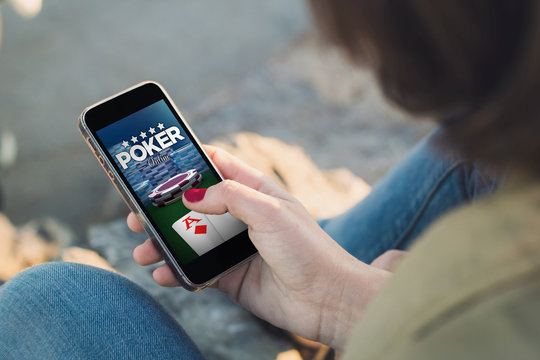 Woman touch the screen of her smartphone poker online