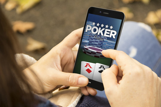 woman with poker online phone in the park