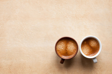 Two coffee espesso cups on brown table. Top view copy space - 113535201