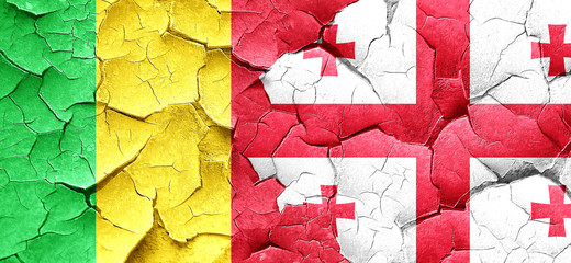 Mali flag with Georgia flag on a grunge cracked wall