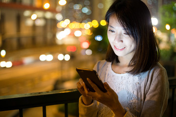Asian woman using cellphone at night