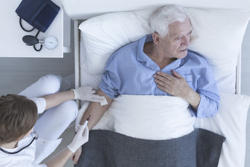 Nurse drawing a blood sample from patient