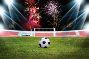 Soccer ball on the field with firework background