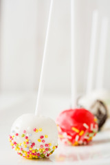 colored cake pops on white background

