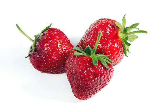 Three ripe strawberries on a white