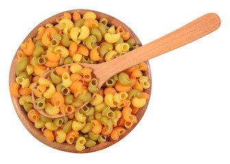 Colored uncooked italian pasta pipe rigate in a wooden bowl on a