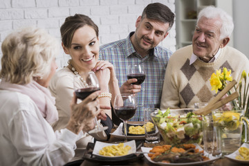 Family drinking wine at the table