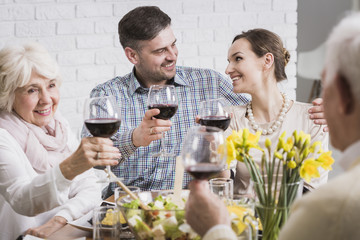 Young happy couple celebrating with wine