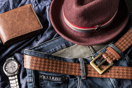 Various fashions of fedora hat, wallet, wrist watch and blue jea
