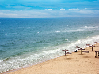 sea coast with thatched umbrellas