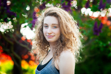 blue eyed curly haired teenage girl outdoors on a summer evening