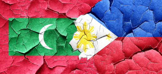 Maldives flag with Philippines flag on a grunge cracked wall