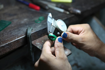 measuring the size of a ring,gold smith making