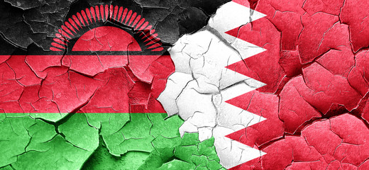 Malawi flag with Bahrain flag on a grunge cracked wall