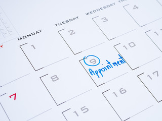 Woman hand write appointment on calendar 2