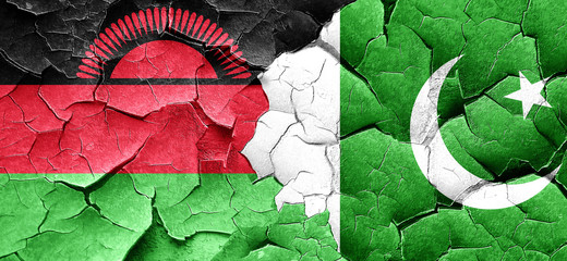 Malawi flag with Pakistan flag on a grunge cracked wall