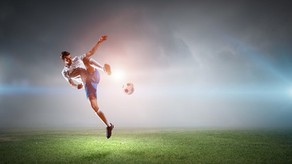 Fototapeta na wymiar Soccer player hitting ball