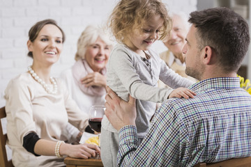 Father and his little daughter at the table