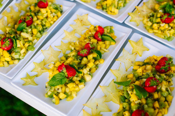 Cut fruits on the white plates