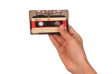 Cassette tape. Hand holding cassette tape isolated on white background.