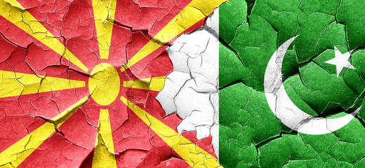 Macedonia flag with Pakistan flag on a grunge cracked wall