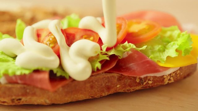 Preparing sandwich with mayonnaise