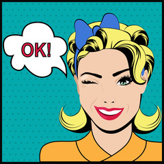 Pop art winking woman saying ok and speech bubble.