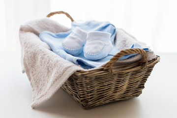 Fototapeta na wymiar close up of baby clothes for newborn boy in basket