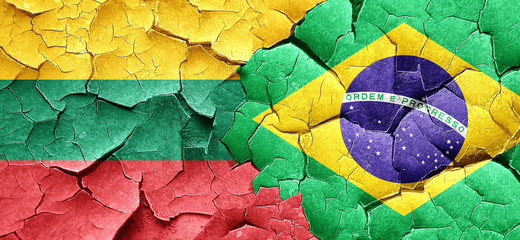 Lithuania flag with Brazil flag on a grunge cracked wall