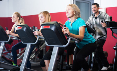 Fitness group riding stationary bicycles