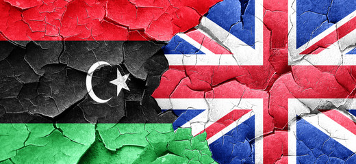 Libya flag with Great Britain flag on a grunge cracked wall