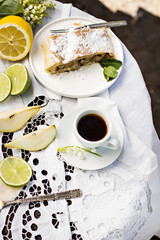 pie, strudel with pear and lemon. Cup of coffee. .Picnic, Breakfast in nature. Food in nature.