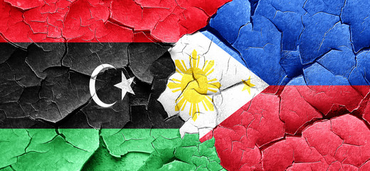 Libya flag with Philippines flag on a grunge cracked wall