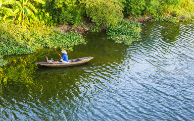 Boats and fisherman in Van Long Natural reserve in Ninh Binh, Vietnam