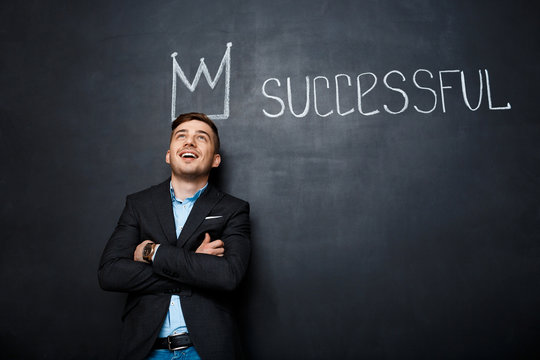 picture of man over blackboard with crown and text successful