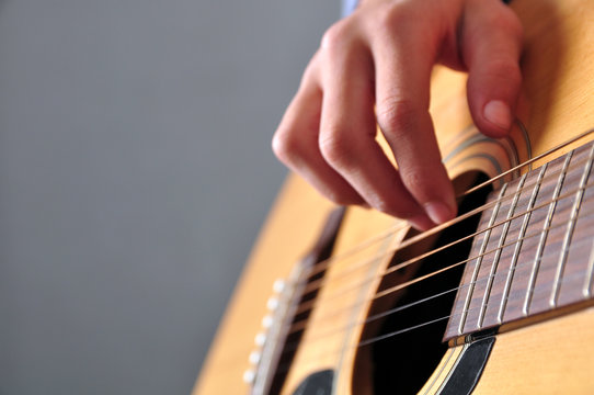 teenager girl playing guitar