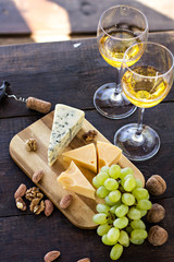 Wine, grapes, nuts, cheese, blue cheese. Dinner, lunch, romantic date, picnic, eating on nature.