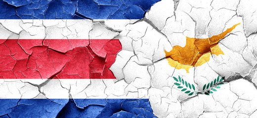 Costa Rica flag with Cyprus flag on a grunge cracked wall