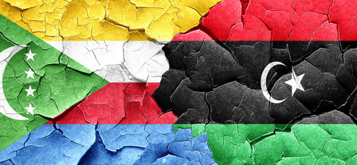 Comoros flag with Libya flag on a grunge cracked wall