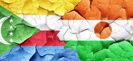 Comoros flag with Niger flag on a grunge cracked wall