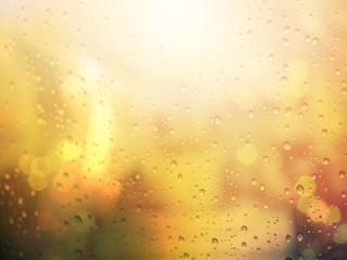 Abstract raindrop on glass window with warm filter and copyspace