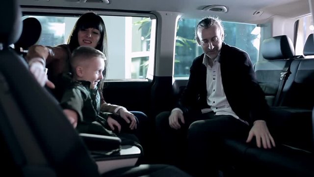 Family inspecting itnerior of minivan