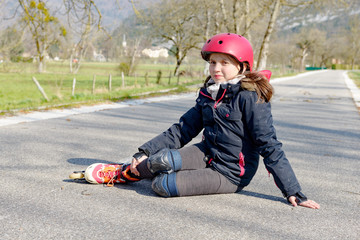 teenage skater grimacing in pain after taking fall