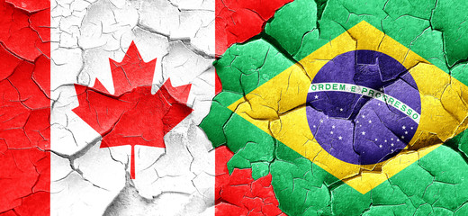 Canada flag with Brazil flag on a grunge cracked wall